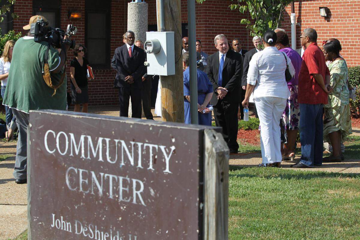 US Senator Dick Durbin is surrounded by housing authority commissioners and other leaders during his visit to the John DeShields housing complex in East St. Louis in 2011