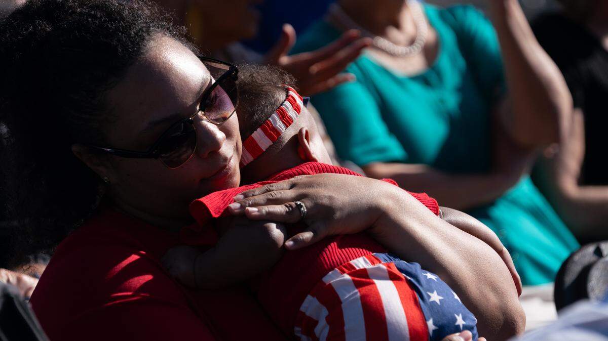 A mother holds her baby at the naturalization ceremony in Belleville’s public square on Sept. 15, 2023. Belleville West is expecting more than 600 prospective new citizens and their families for a similar ceremony Friday.