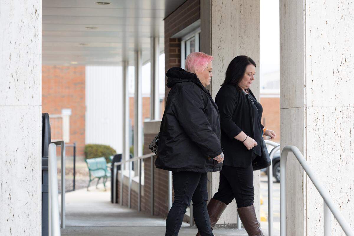 Andrea Hall, right, exits the Madison County Criminal Justice Center on Friday, the last day of testimony in the murder trial of her brother, Neil Howard. She’s with Dawn Hall, her brother’s fiancé.