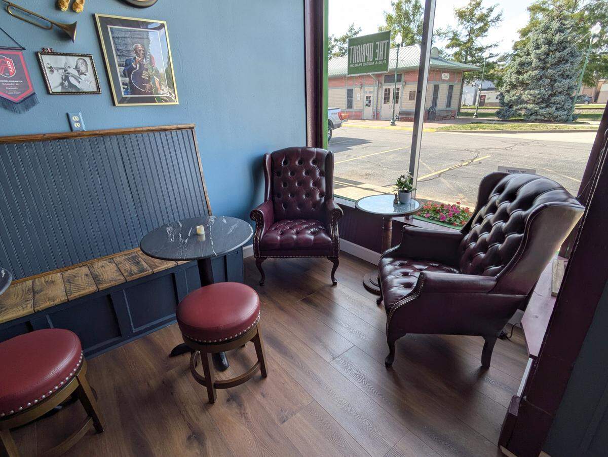 Armchairs in a front corner at The Upright Pub & Music Parlor