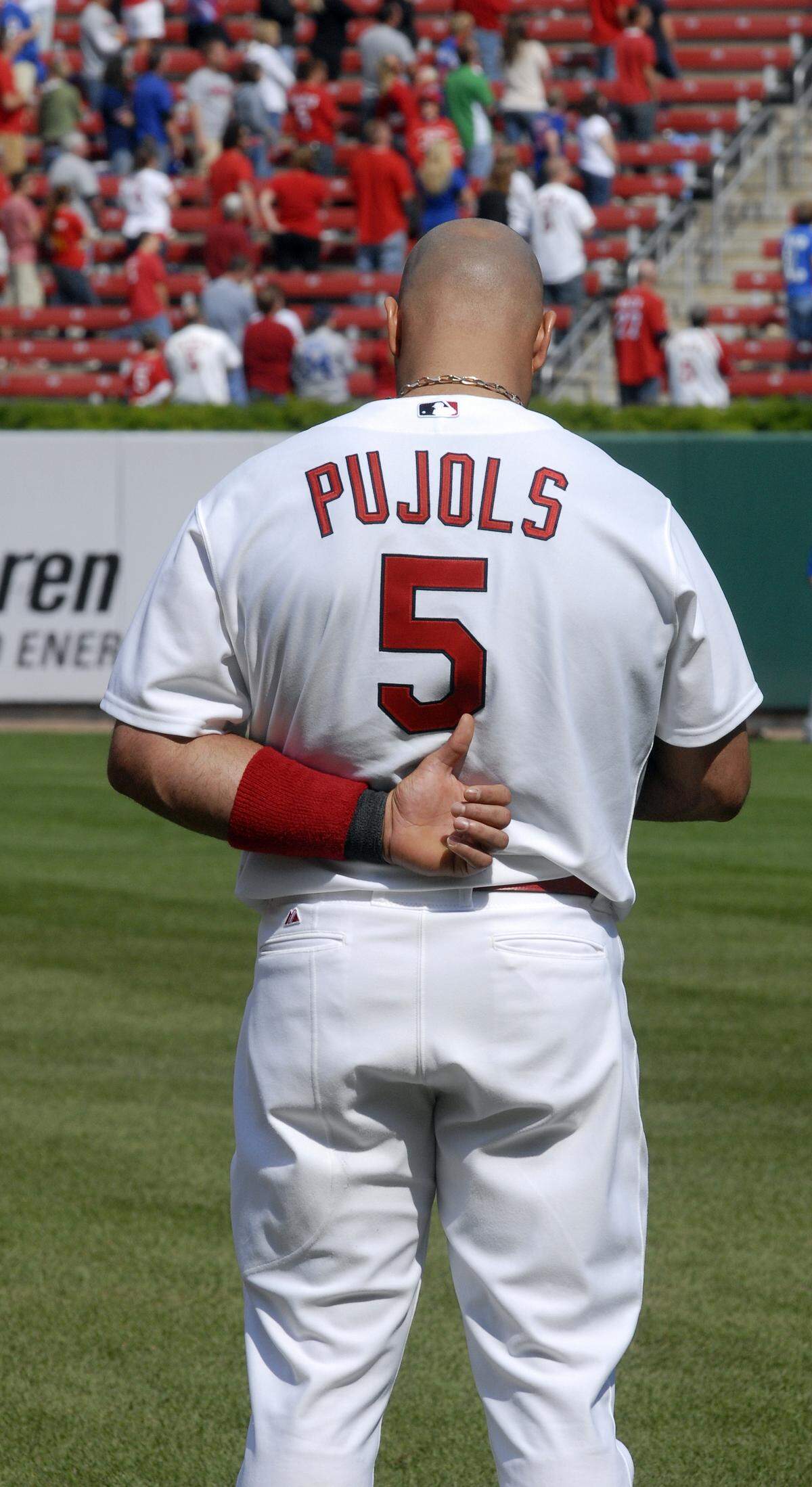 St. Louis Cardinals’ Albert Pujols stands for the national anthem against the Chicago Cubs in the final regular season home baseball game Sunday, Sept. 25, 2011.