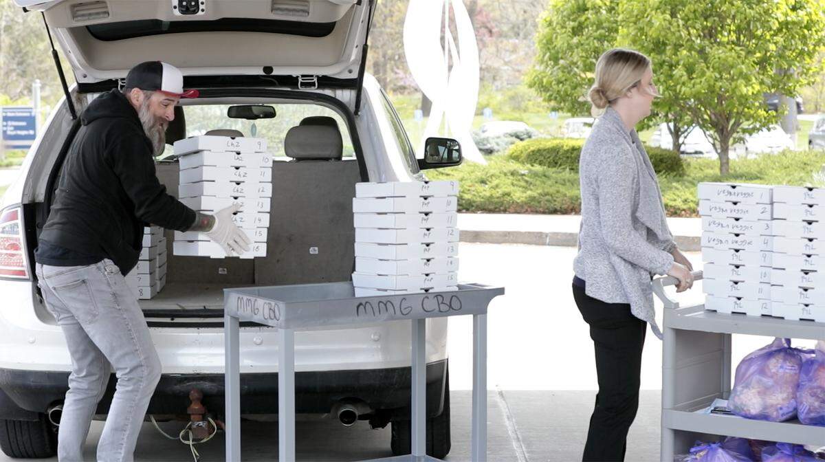 Bennie Parr, left, owner of Bennie’s Pizza Pub in Belleville, delivers 45 pizzas to Memorial Hospital Belleville in April as part of a “Feed the Need” fundraiser for front-line medical workers during the COVID-19 pandemic.