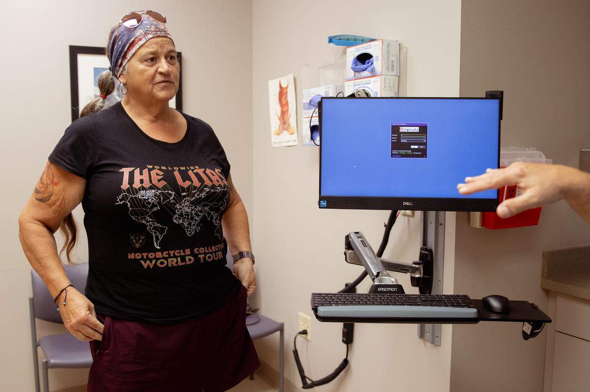 Tina Weber, 54, speaks with her physician after having surgery for diverticulitis on Thursday, Sept. 5, 2024, at Mercy Health Hospital in Creve Coeur.