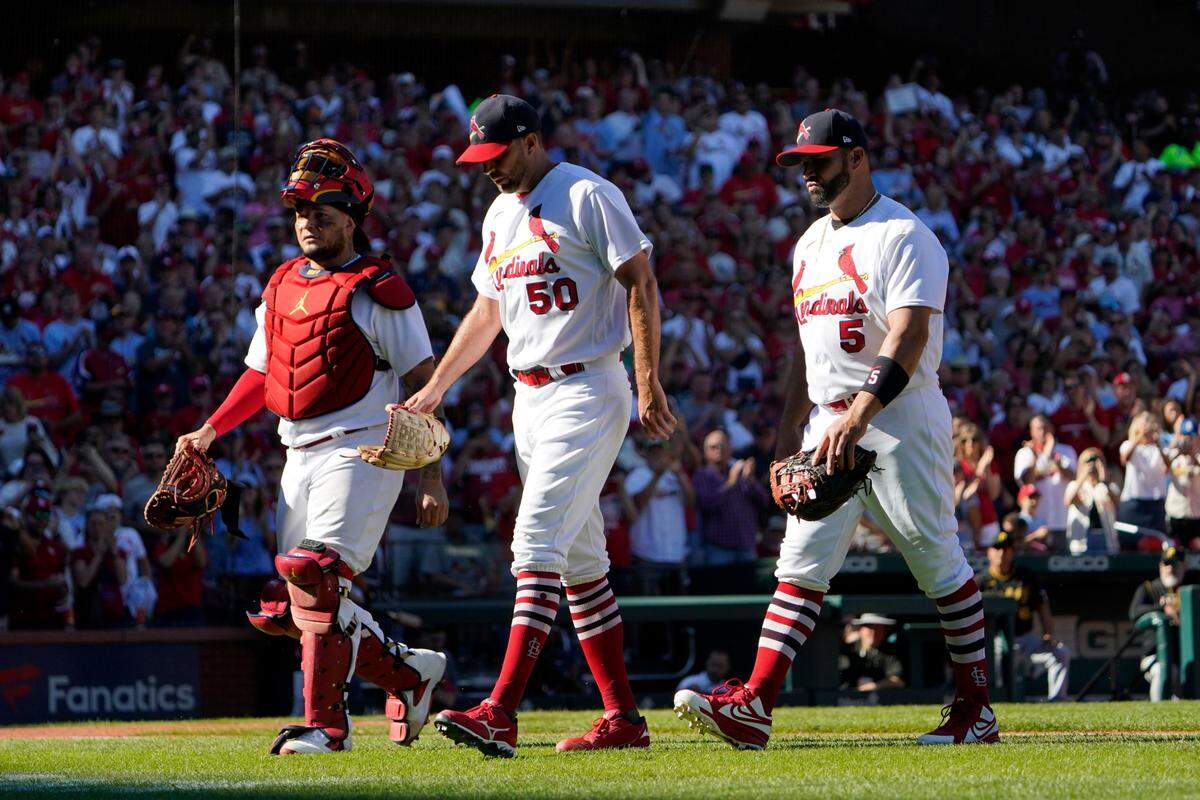 St. Louis Cardinals catcher Yadier Molina, left, starting pitcher Adam Wainwright (50) and first baseman Albert Pujols (5) walk off the field together as they are all removed at the from the game against Pittsburgh at the same time in the fifth inning Sunday in St. Louis. Molina and Pujols retired after the 2022 campaign, while Wainwright is back for one last season in 2023.