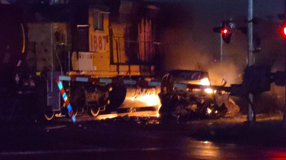 A pickup truck and one of two engines of a Union Pacific train burn after a crash at a railroad crossing early Saturday morning on Mississippi Avenue in Sauget. The truck driver was killed.