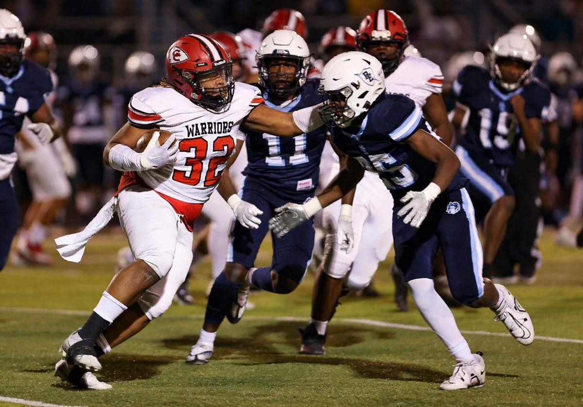 Granite City’s Damarco Dade carries the ball while under pressure during Friday’s non-conference game against Belleville East. The Warriors ultimately fell to the Lancers.