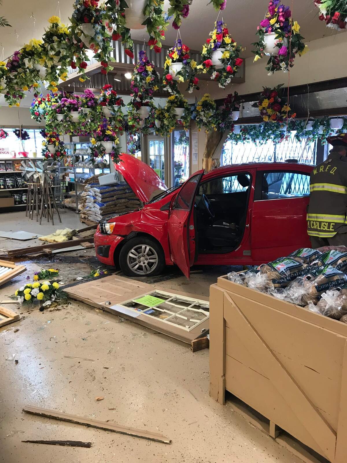 The car crashed through the front doors of the store, causing extensive damage.