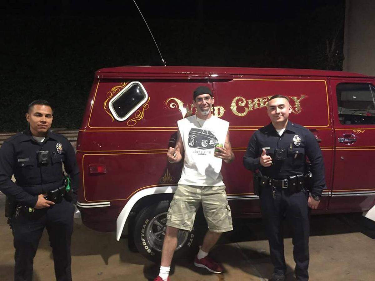 This photo circulating on Facebook shows Chris Carter, who restored the Wild Cherry van, posing with police officers in California, where he cruised on Van Nuys Boulevard on Sept. 19.