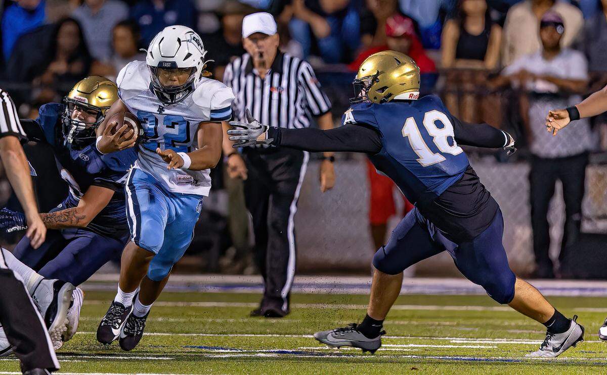 September 13, 2024 - Belleville, IL -Belleville East Machai Henderson (22) breaks away from Althoff Stephen Ache (18) during a boys football game between Althoff and Belleville East on Friday Sept 13, 2024 at SWIC Southwestern in Belleville IL. [Photo: Jimmy Simmons]