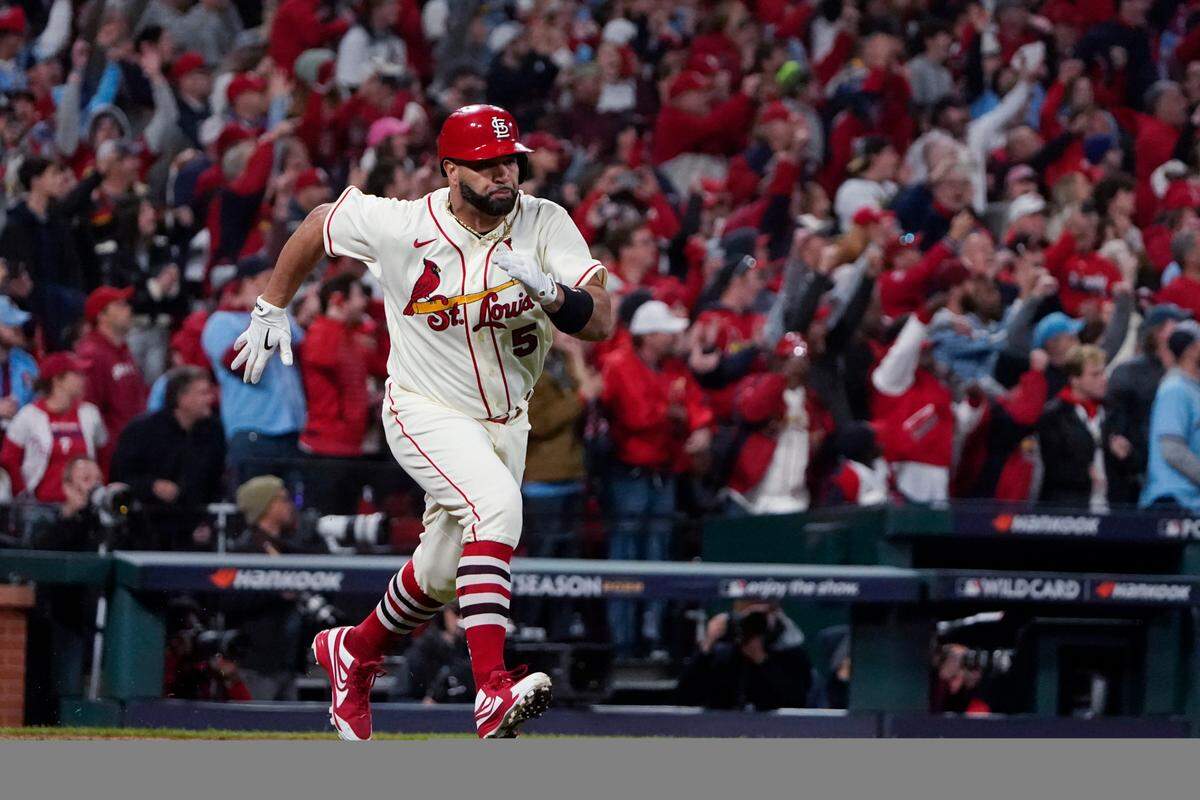 St. Louis Cardinals icon Albert Pujols runs to first base after hitting a single against the Philadelphia Phillies during the eighth inning of Game 2 of an NL wild-card baseball playoff series in October. Pujols enjoyed an outstanding season for the Cardinals in 2022 before retiring.