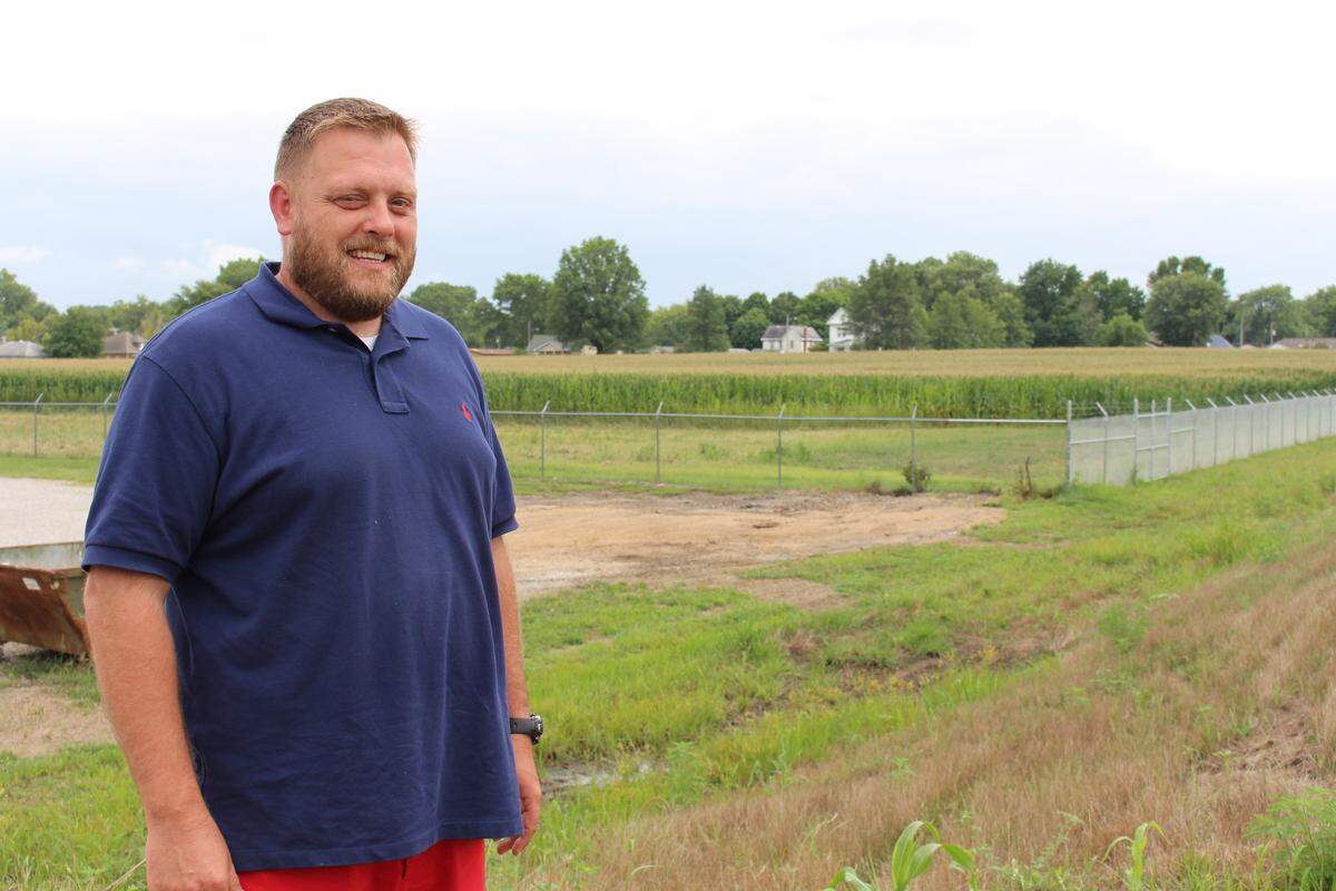 Marissa mayor Chad Easton stands near farmland that the village hopes to convert to solar farms that would provide electricity for the adjacent wastewater-treatment plant and other village buildings.