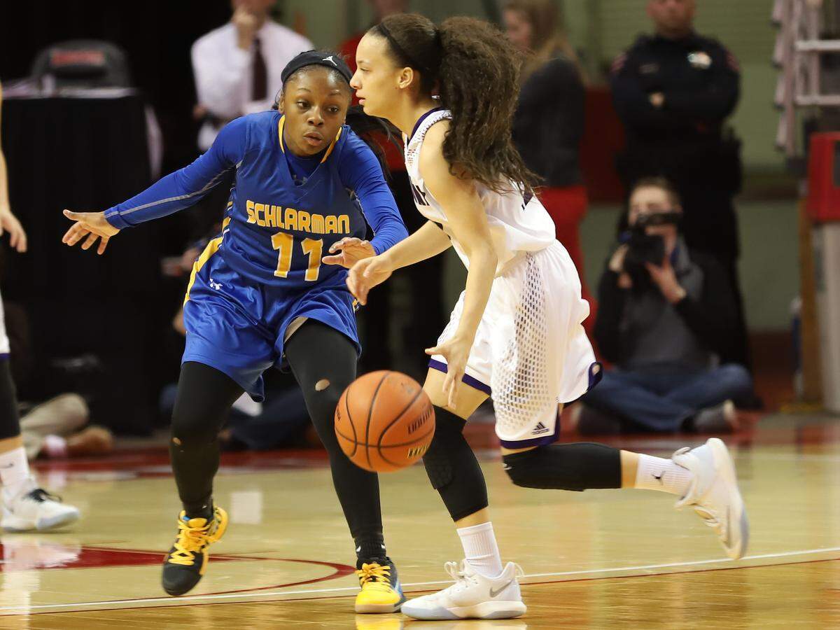 Lebanon's Krista Bass is guarded by Schlarman Academy's Janiah Newell during the first half of the IHSA Class 1A state semifinals Friday afternoon at Redbird Arena in Normal.