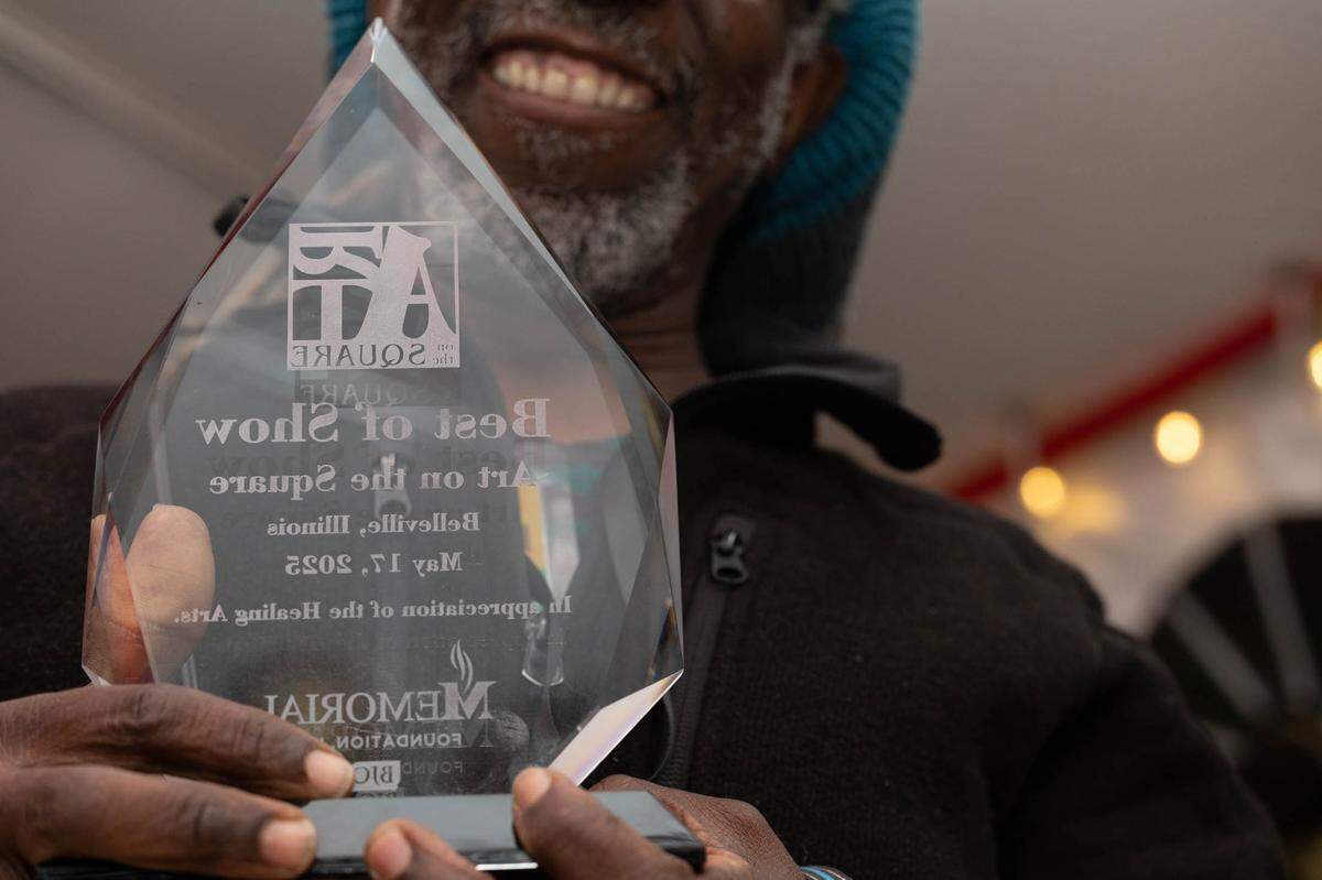 William Kwamena-Poh proudly displays his Best of Show award from Saturday’s Art on the Square awards ceremony. “I cannot believe it,” he said.
