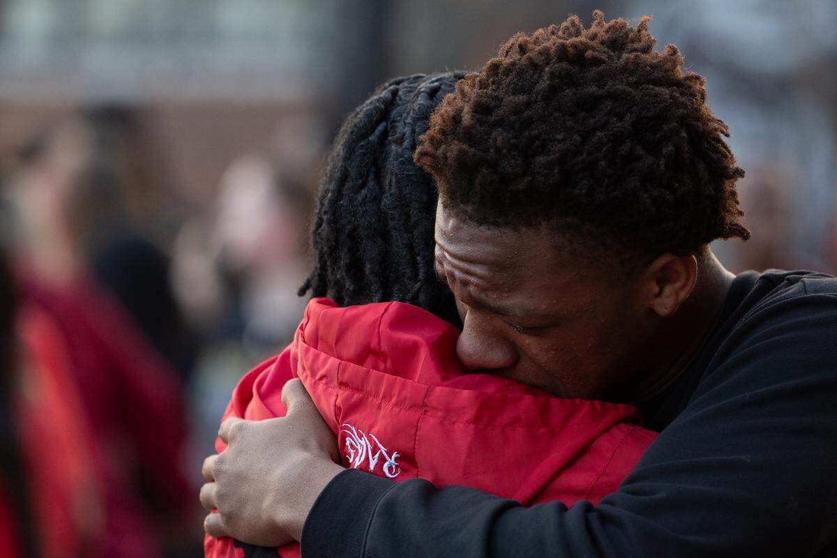 Belleville East sophomore Hernandez Brown hugs a friend after speaking in memory of Jarod Rhodes, a fellow student who passed away unexpectedly last Friday.