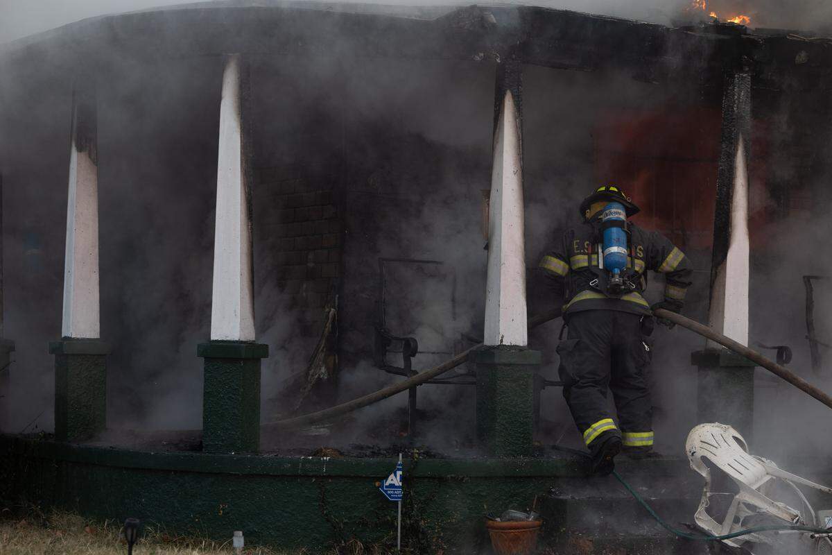 East St. Louis firefighters combat a blaze at a home on Market Avenue on Thursday.