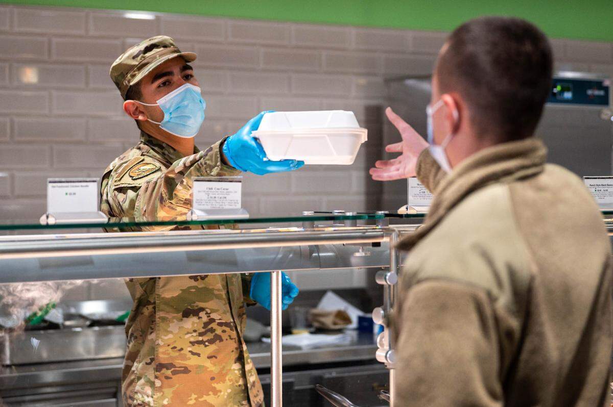 U.S. Air Force Airman Nicolas Vazquez, 375th Force Support Squadron food service apprentice, hands a customer their meal at the Nightingale Dining Facility on Scott Air Force Base. Through hard work and dedication to their craft, the Nightingale Dining Facility staff ensure the best quality food and care comes with every meal.