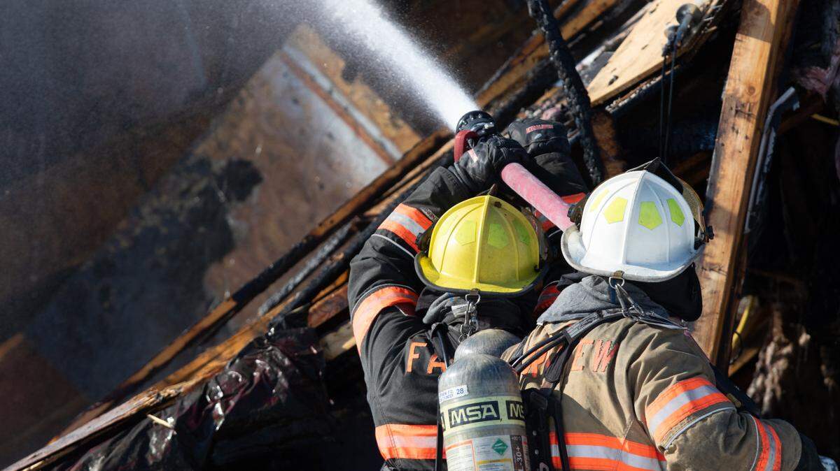 Firefighters from the Fairview Heights fire department battle a blaze at a house fire along Chippewa Drive in Shiloh, Ill. on Jan. 14, 2025.