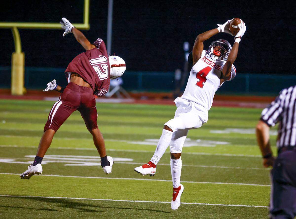 Alton’s Byron Stampley Jr. makes the catch against Belleville West in a Southwestern Conference game. The Redbirds went on to defeat the Maroons 28-7.