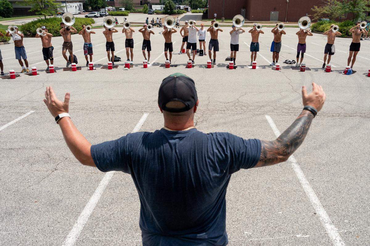 Boston Crusaders brass staff member Jon Virtue leads a warm-up for the drum corps’ low brass section during rehearsal on Tuesday, July 22, 2025, at Pattonville High School in Maryland Heights.