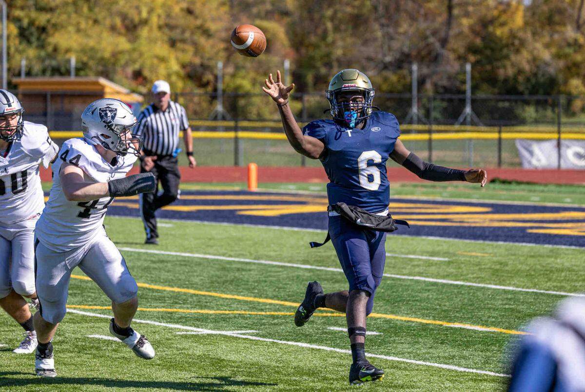 Althoff’s Jayden Ellington (6) passes the ball while under pressure from the Kaneland defense Saturday.