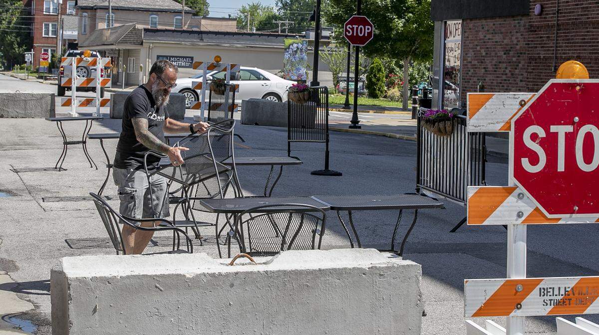 Bennie Parr organizes an expanded outside dining area on Friday morning that will be available for customers of Bennie’s Pizza Pub and Copper Fire restaurant and bar in downtown Belleville.