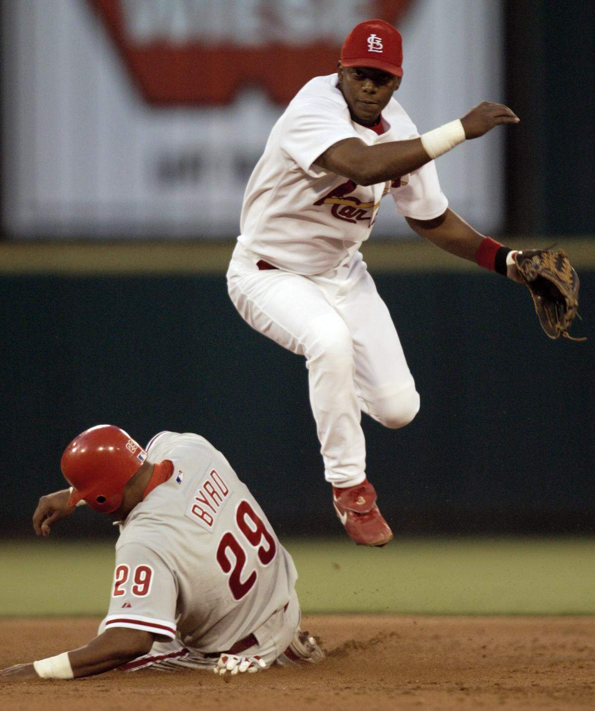 St. Louis Cardinals’ Edgar Renteria leaps to avoid Philadelphia Phillies Marlon Byrd after forcing Byrd out at second and throwing Placido Polanco out at first to complete the double play in the third inning Tuesday, April 27, 2004, in St. Louis. (AP Photo/Tom Gannam)