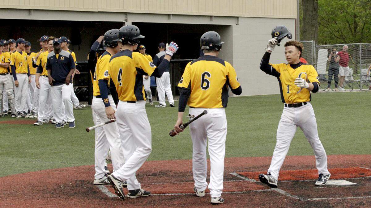 Teammates greet O'Fallon shortstop Josh Gibson at home plate after he hit a grand slam in the first inning Friday in the Panthers' win over Mascoutah at Blazier Field.