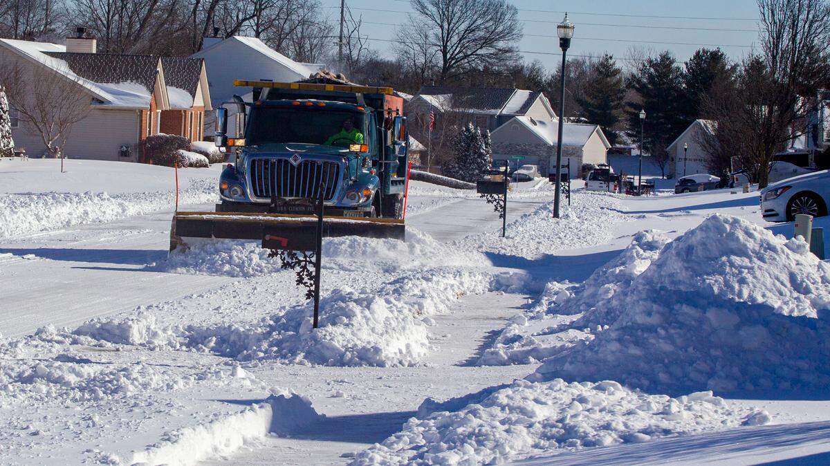 A Fairview Heights public works employee clears the streets in a neighborhood on Feb. 16, 2021. Schools are canceling school this week because of a snow storm.
