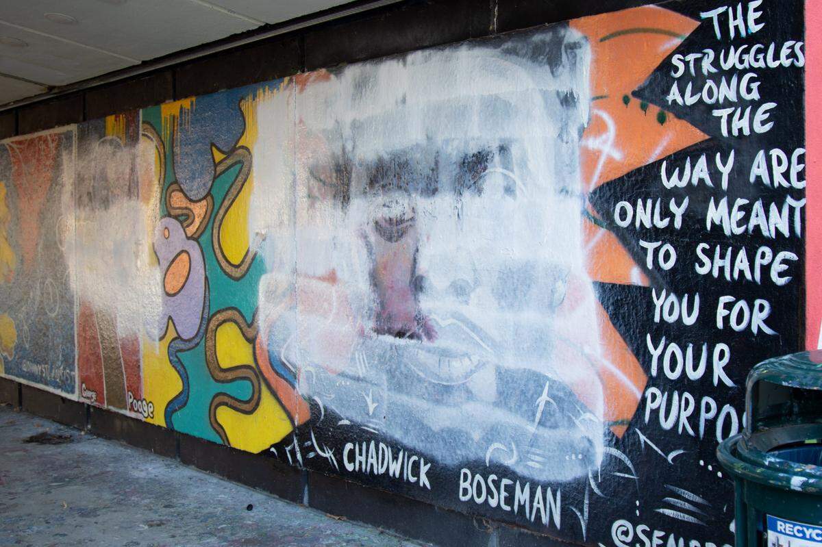 A white base coat remains, obscuring an image of the late actor Chadwick Boseman, after students tried to clean white nationalist graffiti off a mural of famous Black Americans at Washington University in St. Louis in December.