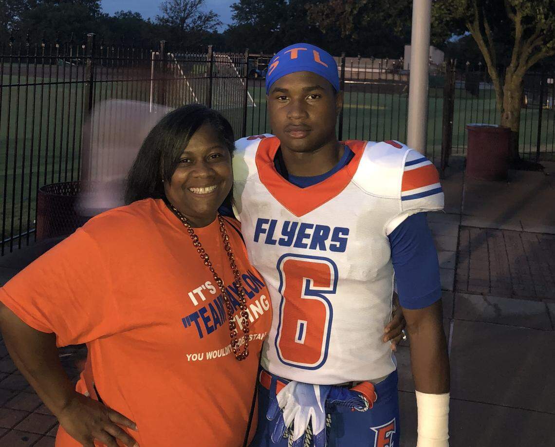 Jaylon McKenzie poses with his mother, Sukeena Gunner, at an East St. Louis Junior Flyers football game.