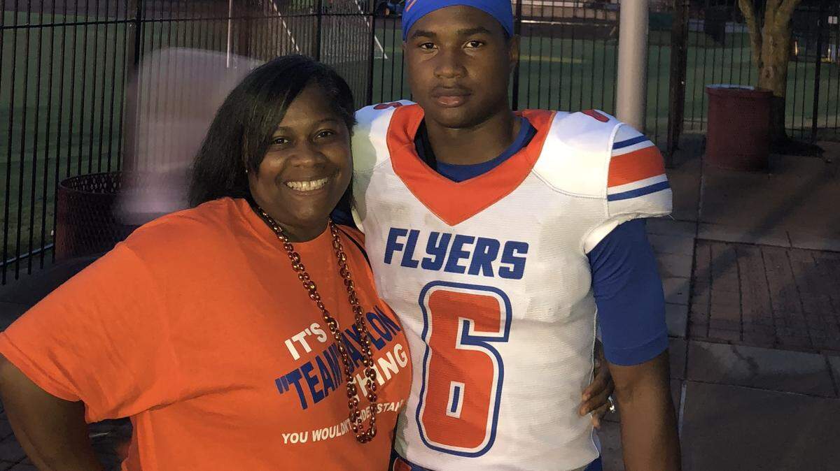Jaylon McKenzie poses with his mother, Sukeena Gunner, at an East St. Louis Junior Flyers football game. He was killed by a stray bullet at a Venice house party in 2019.
