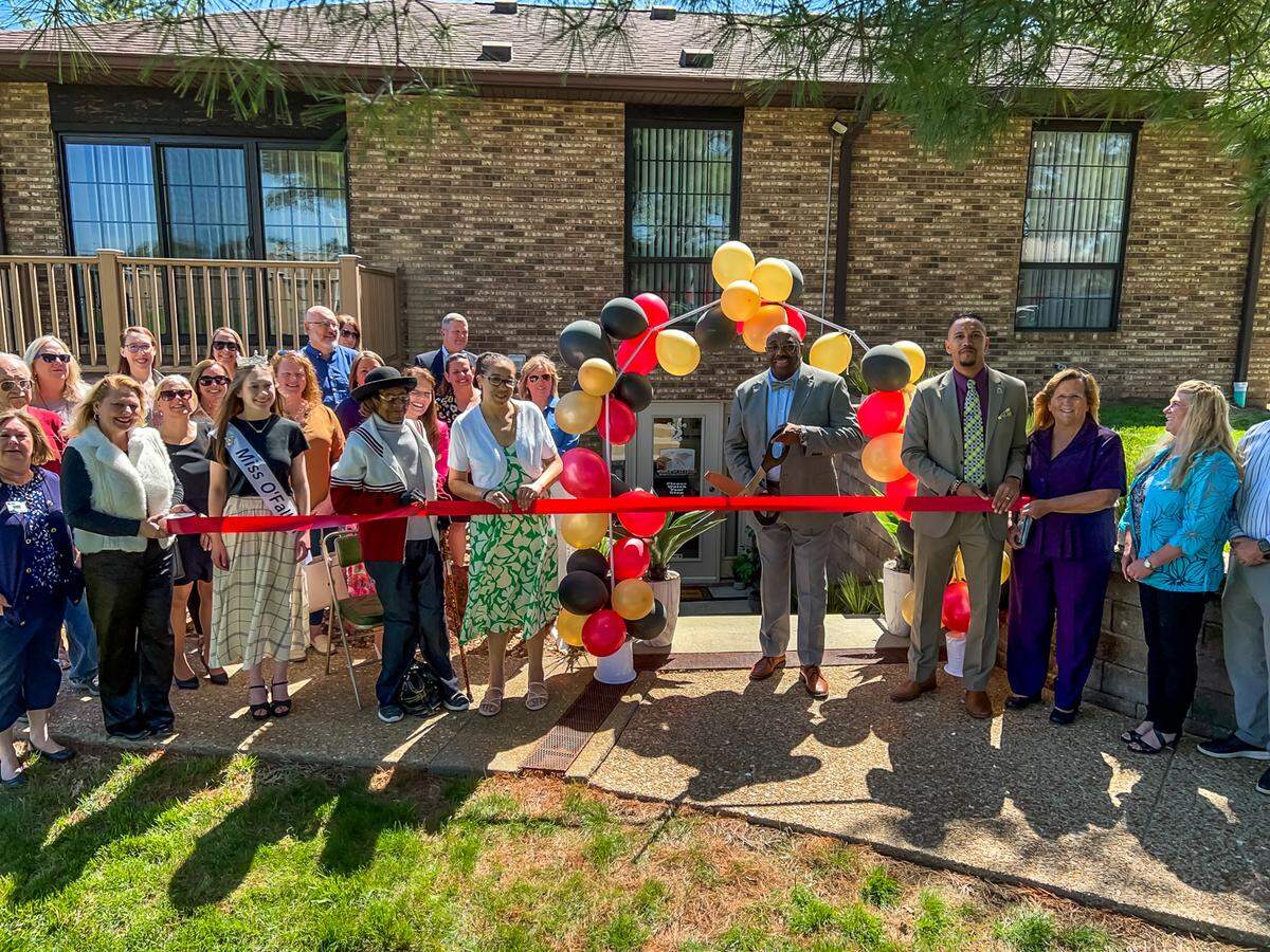World of Authors, Writer’s Enrichment Center owner Reggie Harwell cuts the ribbon at the centers grand opening event on April 11.
