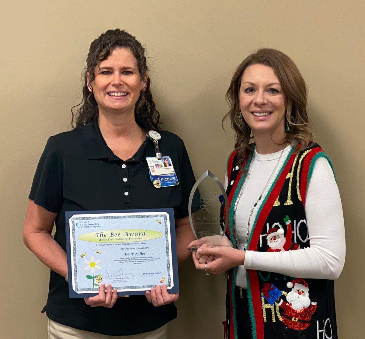 Teresa Cornelius, right, chief nursing officer, presents Kelly Zeller, left, physical therapy assistant, with the Being Extraordinary Everyday (BEE) Award at HSHS St. Joseph’s Hospital Highland. (Masks were removed temporarily for photo.)