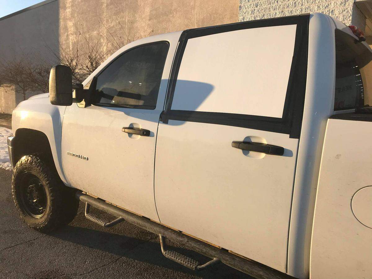 The owners of this Chevrolet Silverado 2500HB truck taped up the rear window on the driver’s side after it was vandalized in the parking lot of St. Clair Square mall on Saturday.