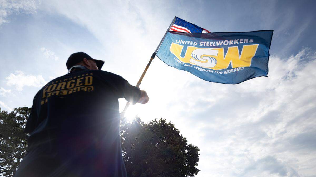 A United Steelworkers member holds up a flag during a rally in Granite City on Saturday.