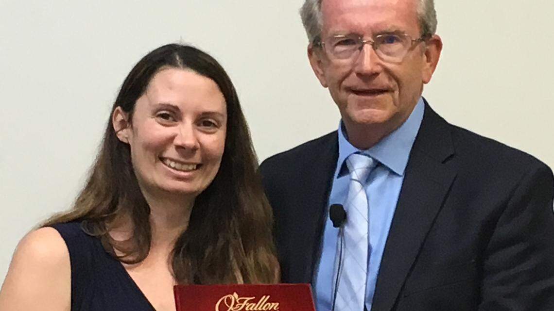 Ward 5 Alderman Courtney Marsh, who announced her resignation Monday, receives a plaque from Mayor Herb Roach.