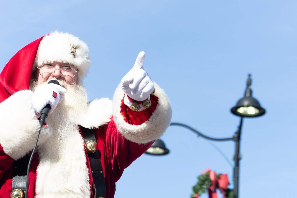 The man in red himself gives lessons on correct behavior as he makes his way down Belleville’s Main Street during the 2025 annual Santa Parade .