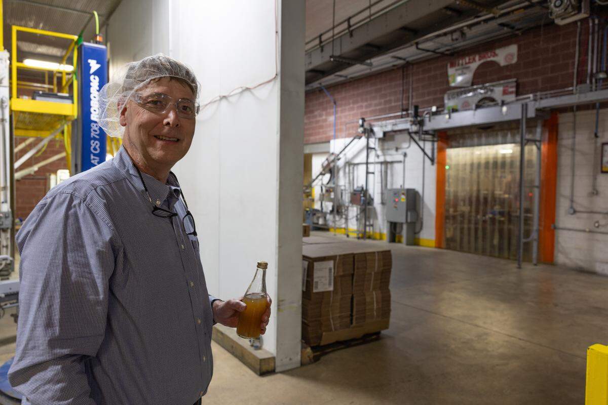 Excel Bottling Co. president Bill Meier drinks a freshly-produced tea and lemonade drink while on the production floor of the company’s Breese factory location.