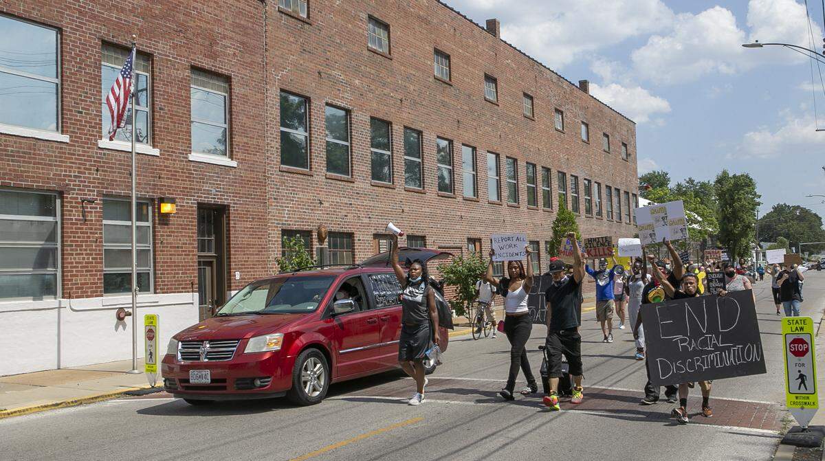 About 40 people gathered outside Empire Comfort Systems in Belleville on June 19, 2020, before marching downtown in a Black Lives Matter protest planned by an employee who has accused the company of allowing racial discrimination.