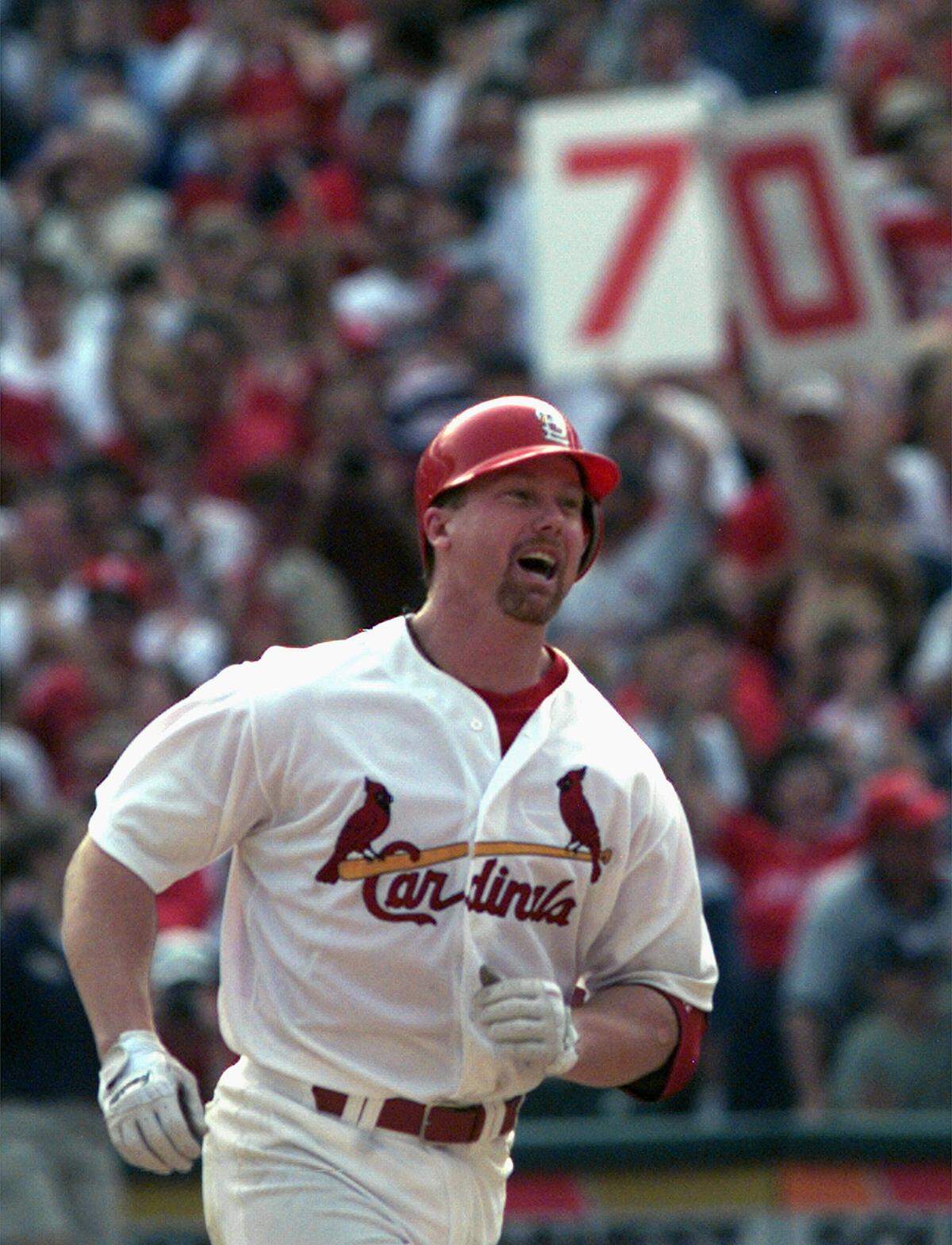 Mark McGwire smiles as he rounds the bases after hitting his 70th home run of the season in the seventh inning against Montreal Expos pitcher Carl Pavano, at Busch Stadium in St. Louis, Sept. 27, 1998. (AP Photo/Amy Sancetta, File)