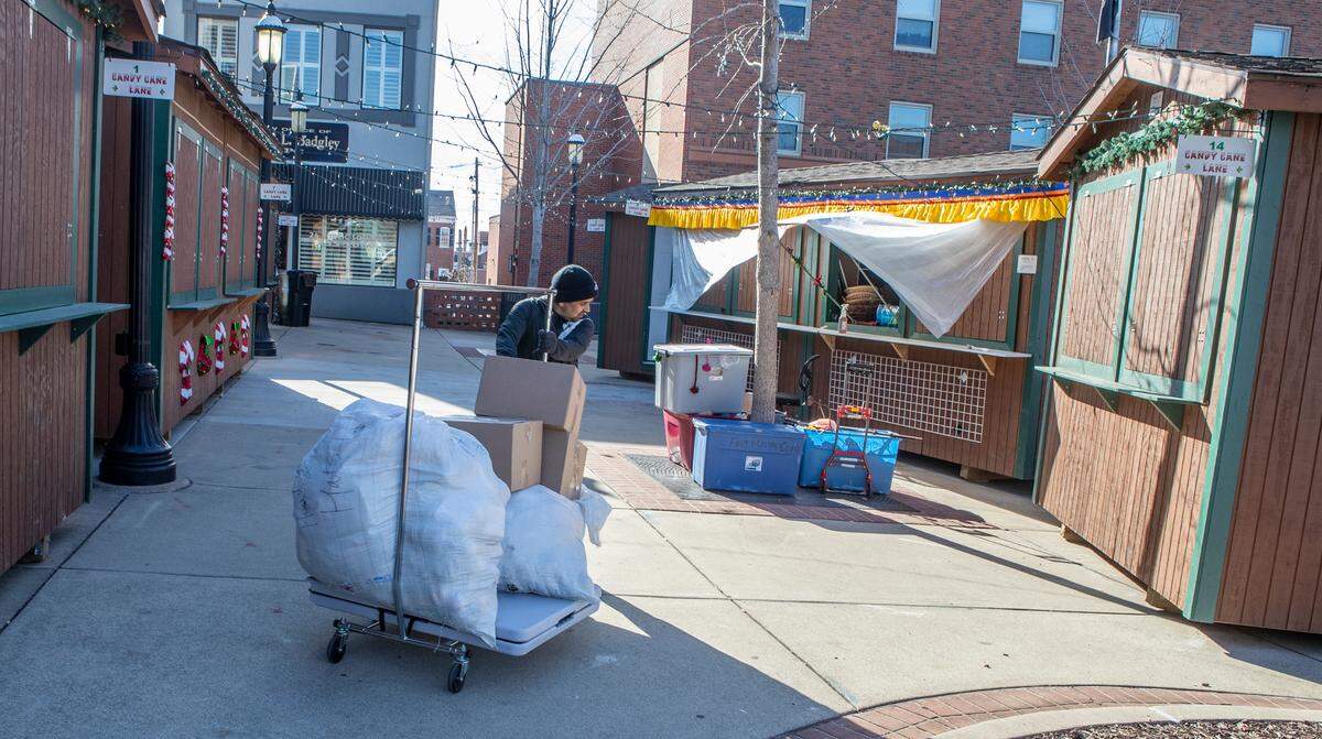 A worker brings product to stock and prepare the Whimzy Collection booth for opening day of the Belleville Christkindlmarkt on Friday, Nov. 25, from 9 a.m. to 8:30 p.m. on the Public Square. The Whimzy Collection features colorful, handcrafted wool and felt products from Nepal. The open-air German style holiday market will feature a variety of vendors including, woodworking, photography, ornaments, German bakery, Polish pottery, and much more. For a complete schedule and vendor list visit www.bellevillechristkindlmarkt.com/