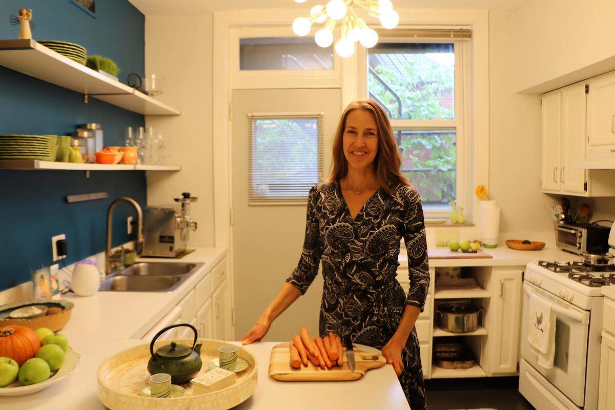 Cancer survivor Amy Johnson stands in her Central West End home’s kitchen. In 2013, Johnson was diagnosed with clear cell carcinoma. To fight the illness she used a holistic healing approach called Gerson’s Therapy, which requires the consumption of more than 90 pounds of fruits and vegetables a week, taking supplements and performing several coffee enemas a day for two years.