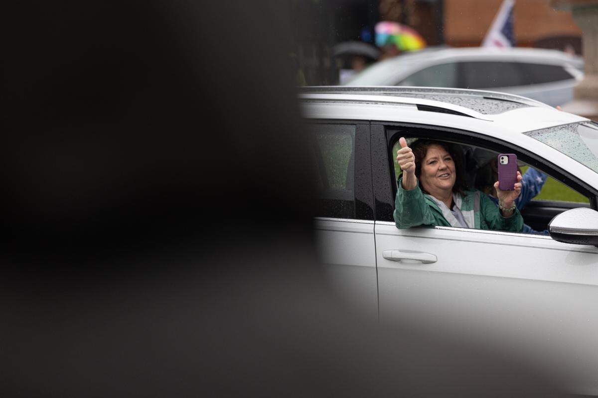 A motorist gives a supportive thumbs-up as they pass by protesters on Belleville’s Public Square.