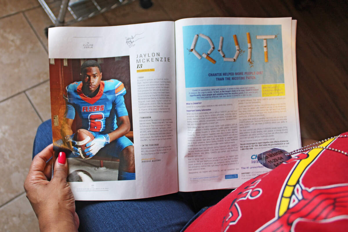 At her home in Belleville, Sukeena Gunner thumbs through a copy of Sports Illustrated. Her son, Jaylon McKenzie, was featured in the magazine’s “Future Issue” in 2018. Seven months later, Jaylon was fatally shot at a house party in Venice.