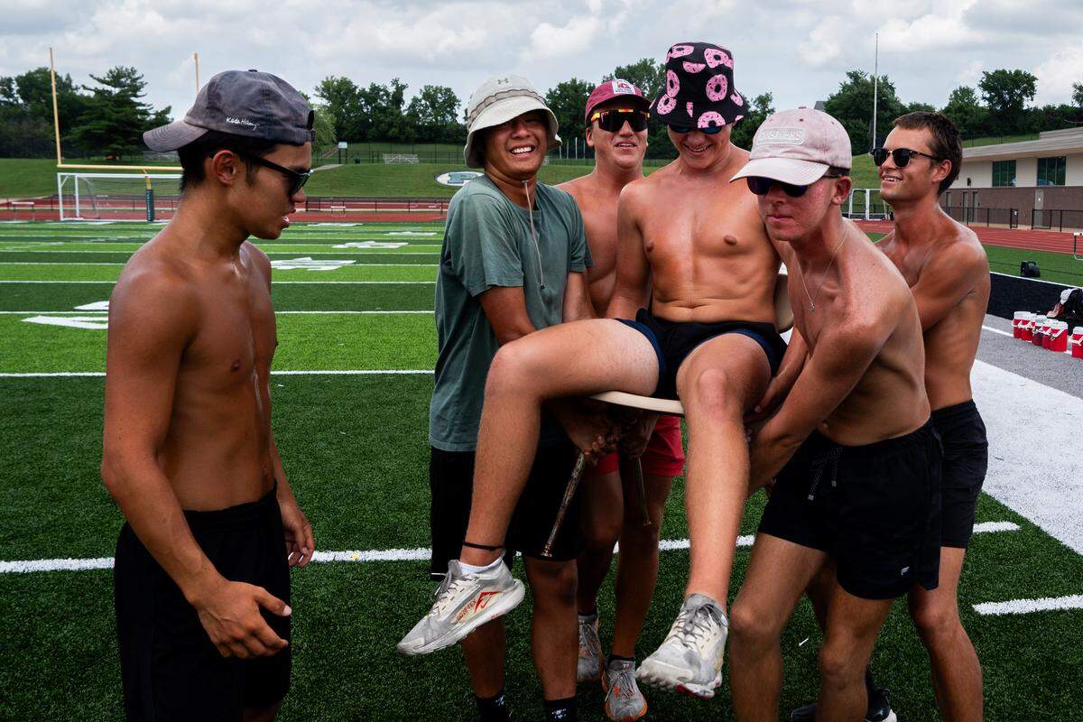 Members of the Boston Crusaders’ contra line goof around during warm-ups at a rehearsal on Tuesday, July 22, 2025, at Pattonville High School in Maryland Heights.