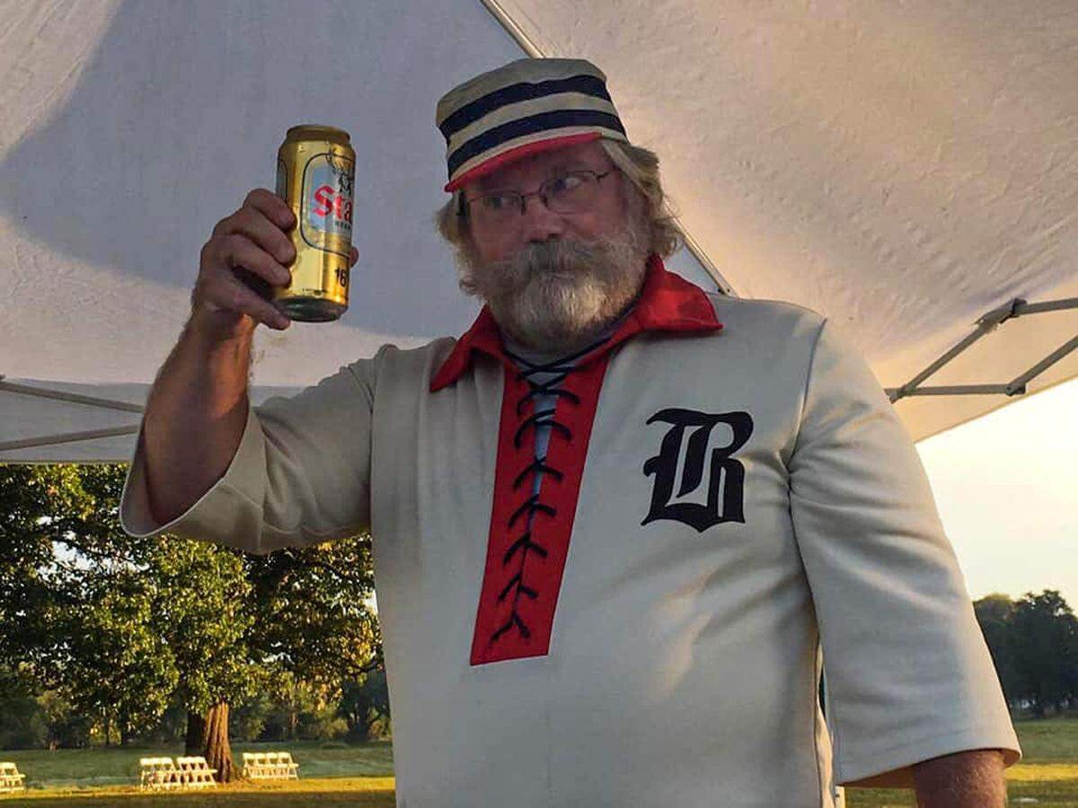 Michael “Mule” Garrett, a member of the Belleville Stags Vintage Base Ball Club, demonstrates the team’s second-favorite pastime: Drinking Stag beer after games. All the players have nicknames.
