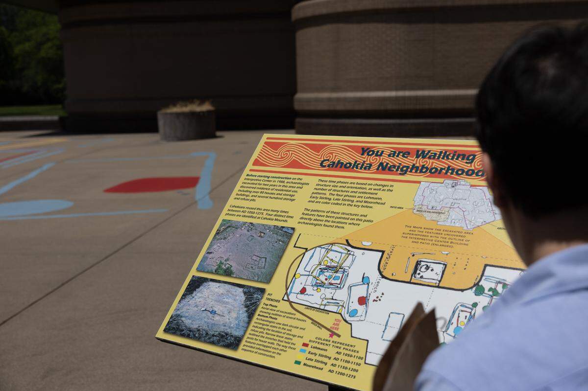 Site service specialist Angela Cooper examines an informational plaque at Cahokia Mounds State Historic Site July 5.