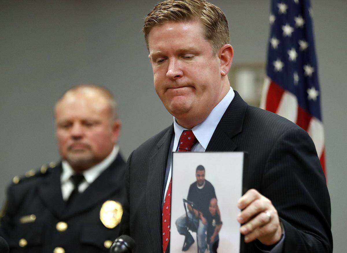 Former St. Clair County State’s Attorney Brendan Kelly holds a photo showing Quiantez Fair (in left of photo he is holding). Fair was killed on October 2nd, 2017 in East St. Louis.