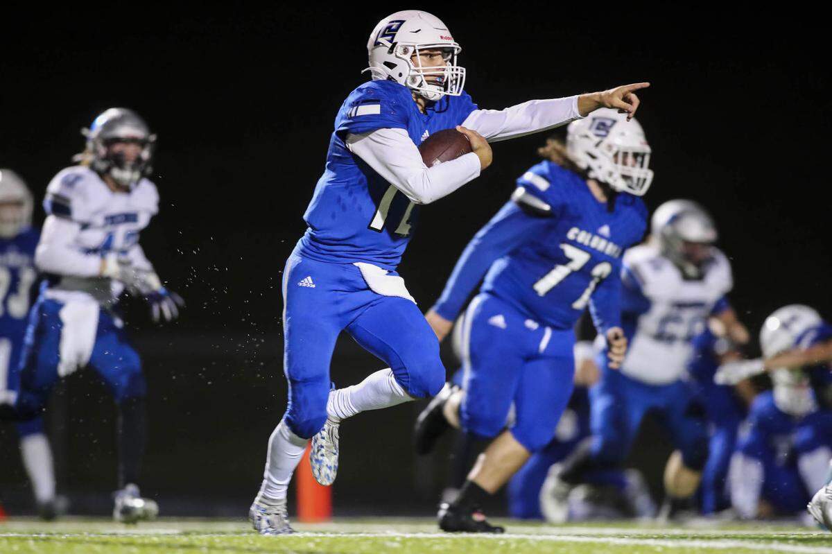 Columbia’s Dominic Voegele (12) directs his blockers as he carries the ball for a touchdown during the second quarter of a Cahokia Conference game against Freeburg on Friday night. Behind Voegele’s big night and a stout showing from the defense, the Eagles ultimately posted a 24-0 win.