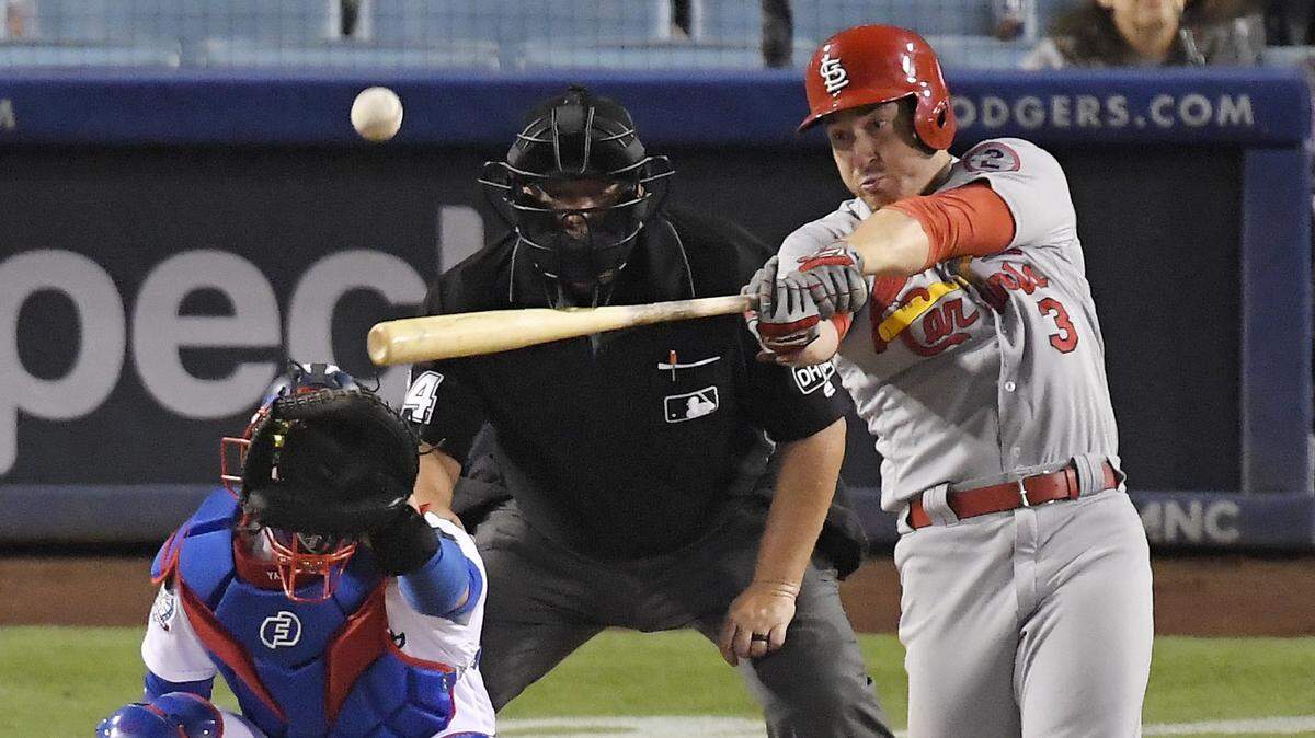 St. Louis Cardinals’ Jedd Gyorko, right, hits a solo home run as Los Angeles Dodgers catcher Yasmani Grandal, left, watches along with home plate umpire Sam Holbrook during the ninth inning of a baseball game Monday, Aug. 20, 2018, in Los Angeles. The Cardinals won 5-3.